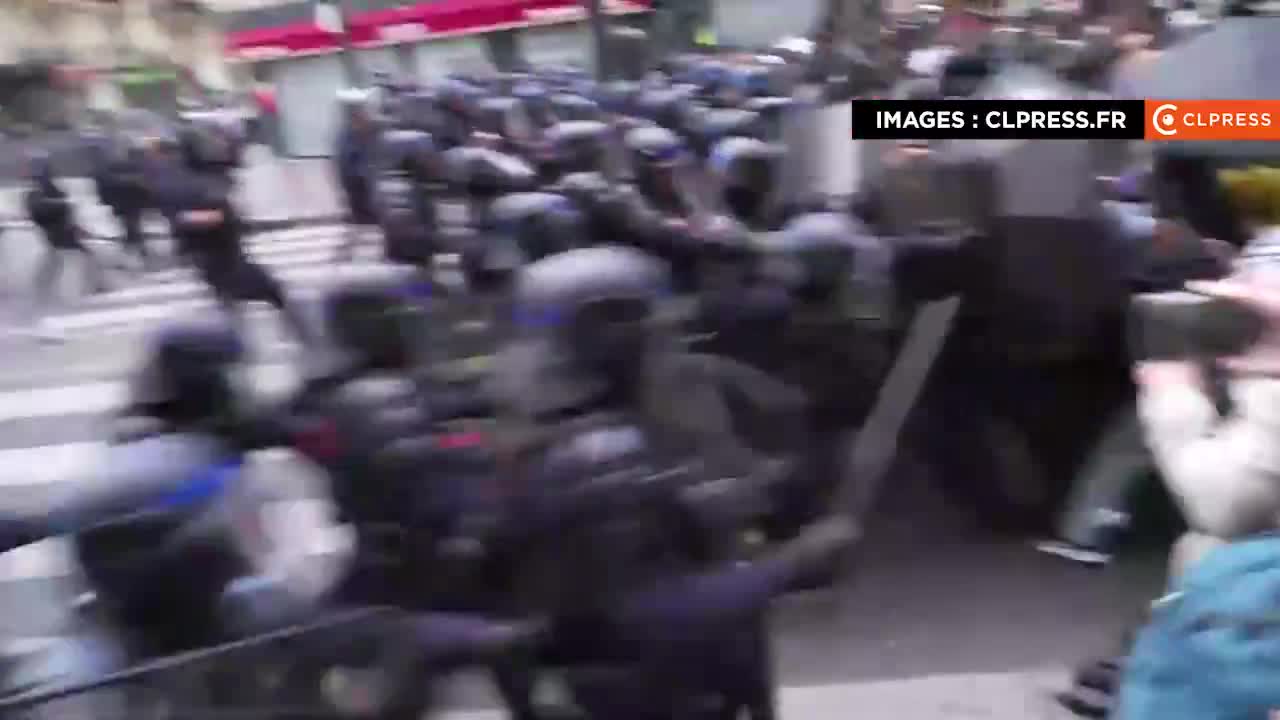New police charge in Paris to push back a group of protesters who are facing them while trying to escape from a net