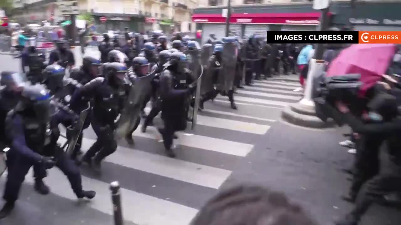 New police charge in Paris to push back a group of protesters who are facing them while trying to escape from a net