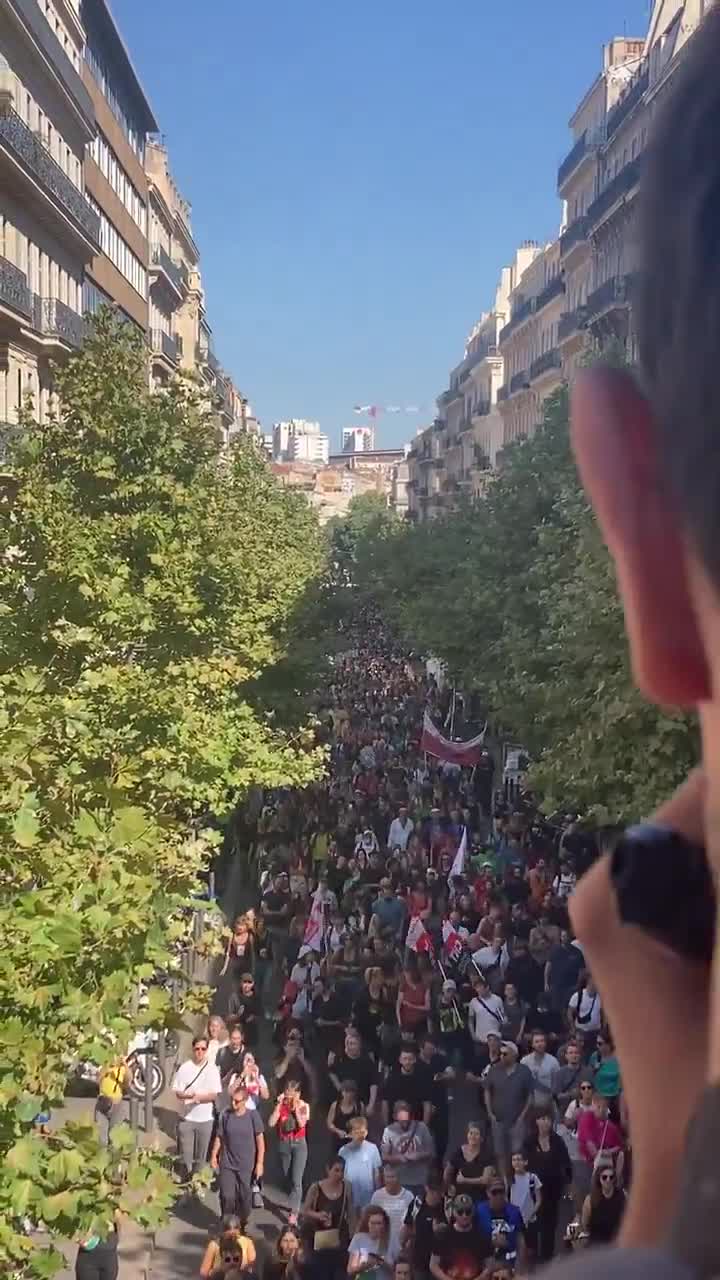 A human tide surges through the streets of Marseille