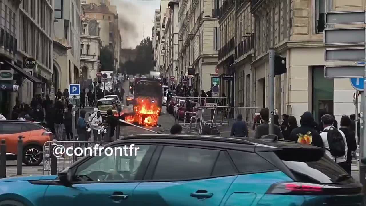 Flames engulf barricade in Marseille's Joliette district.