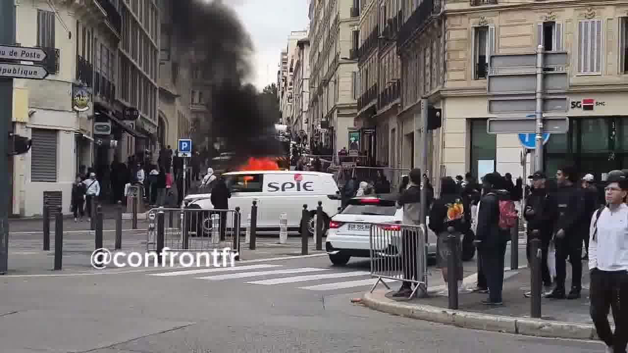 Flames engulf barricade in Marseille's Joliette district.