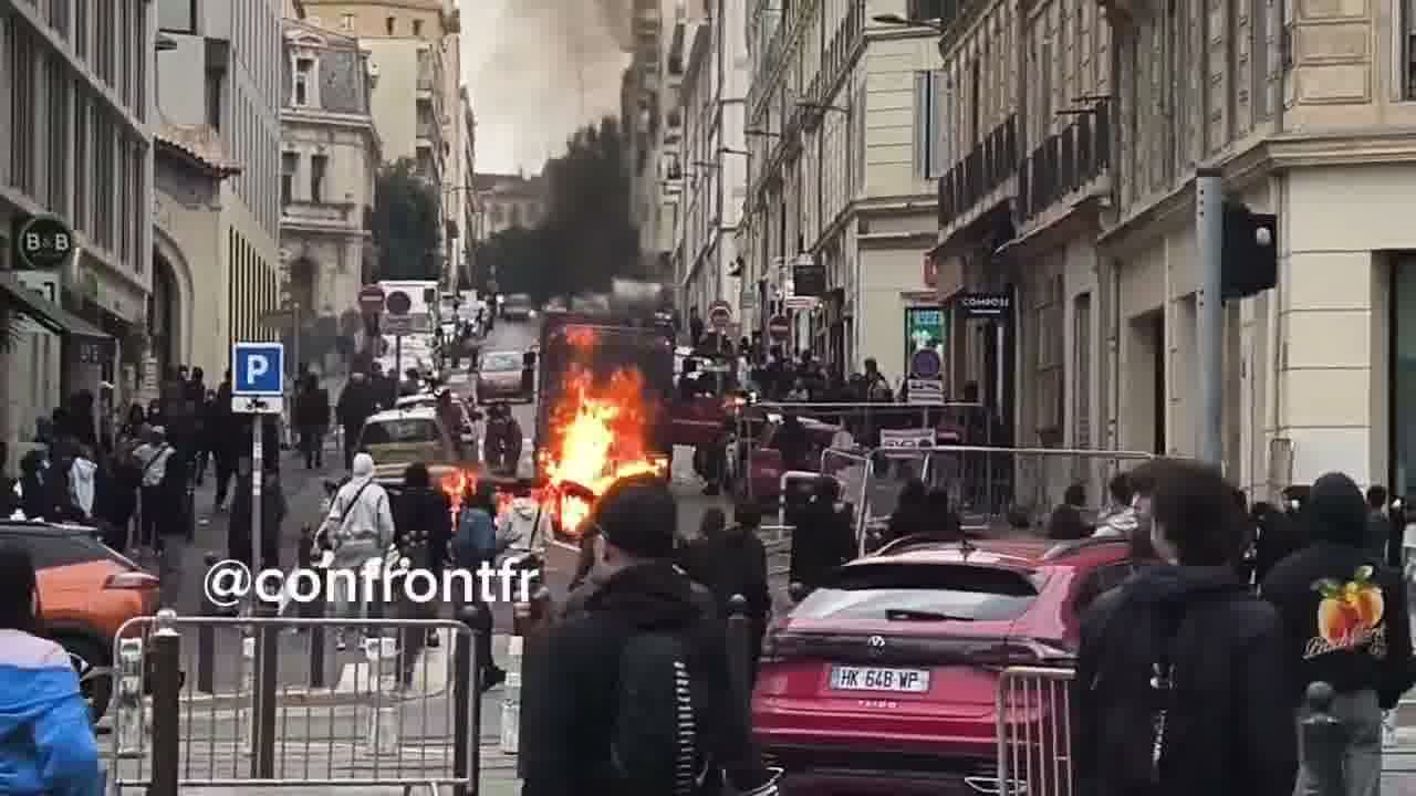 Flames engulf barricade in Marseille's Joliette district.