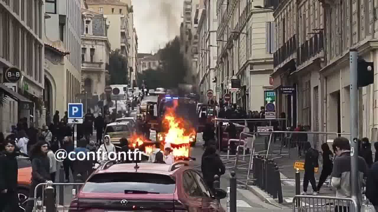 Flames engulf barricade in Marseille's Joliette district.