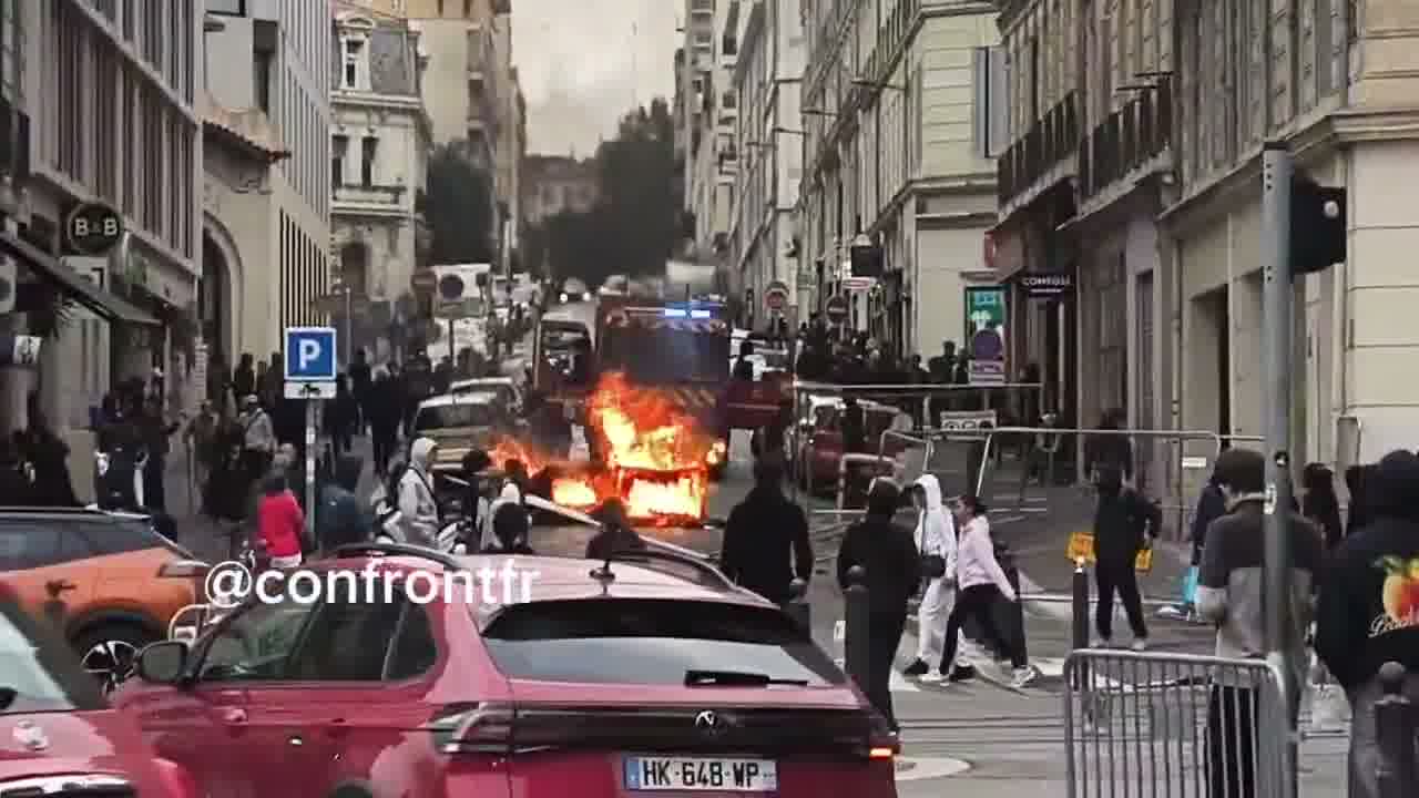 Flames engulf barricade in Marseille's Joliette district.