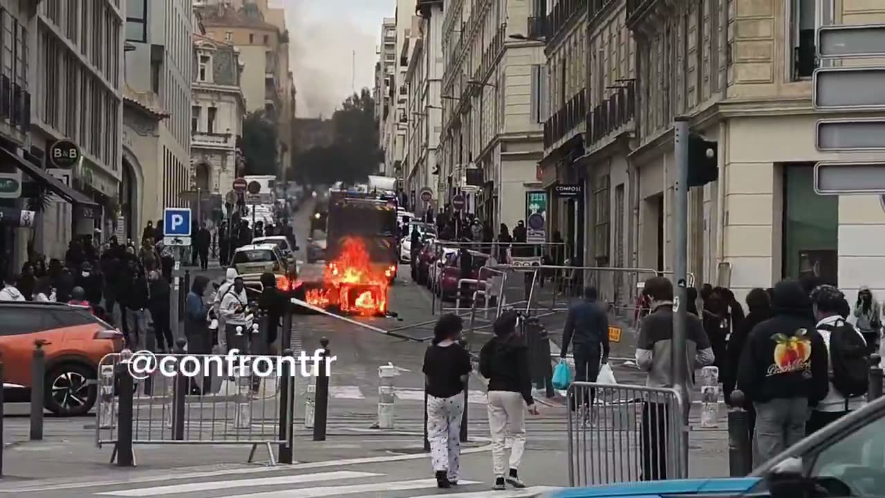 Flames engulf barricade in Marseille's Joliette district.