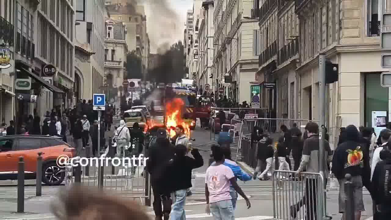 Flames engulf barricade in Marseille's Joliette district.